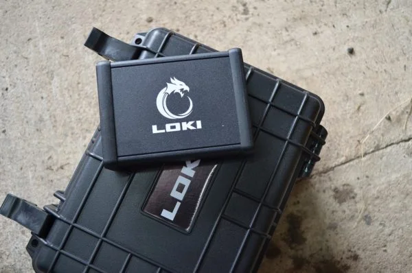 Loki Diagnostic device ontop of it's carrying case, outside
