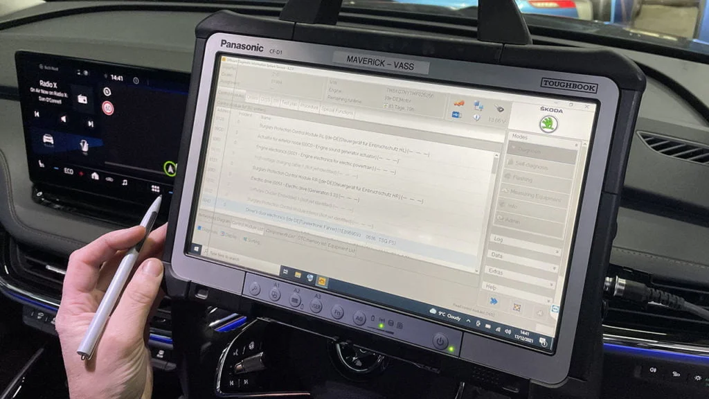 Diagnostic Tablet PC sitting on the steering wheel of a car