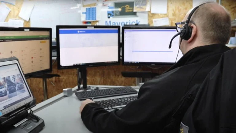 Picture depicts Dave, our technical support director, sitting infront of three computer screens