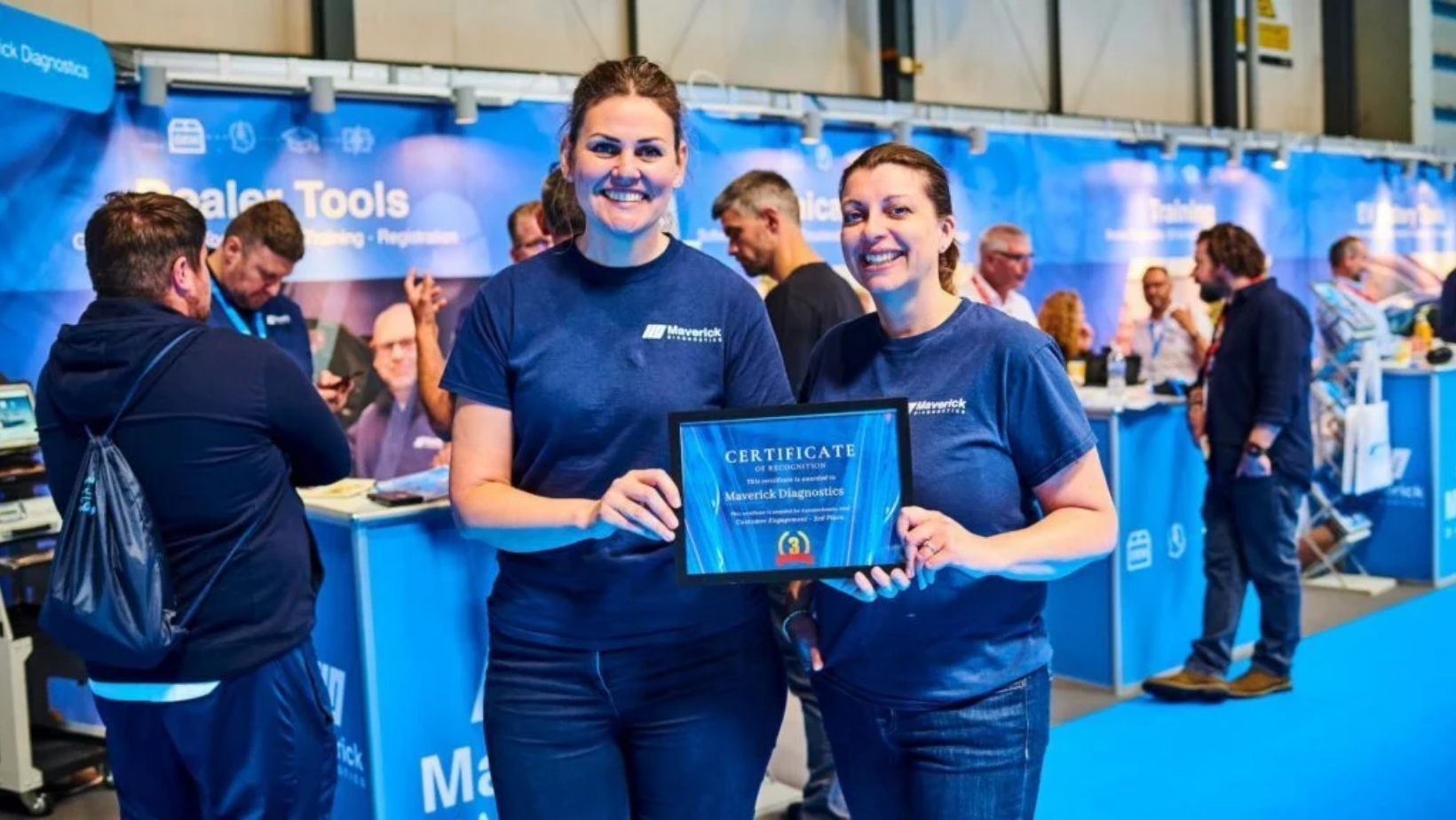 Laura and Beth at Automechanika holding the customer engagement award