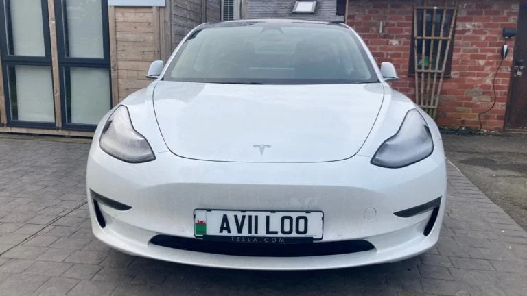 White Tesla model 3 with AVILOO number plate