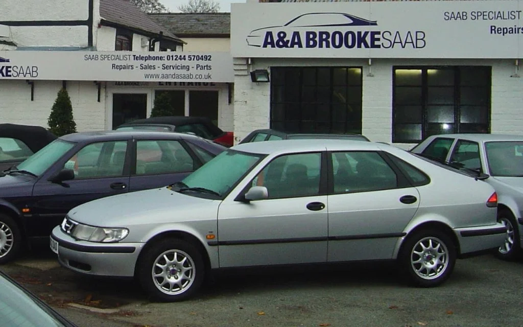 a SAAB 900 infront of a garage in Rossett, Wales. Sign reads: A&A BROOKE SAAB, SAAB SPECIALIST.